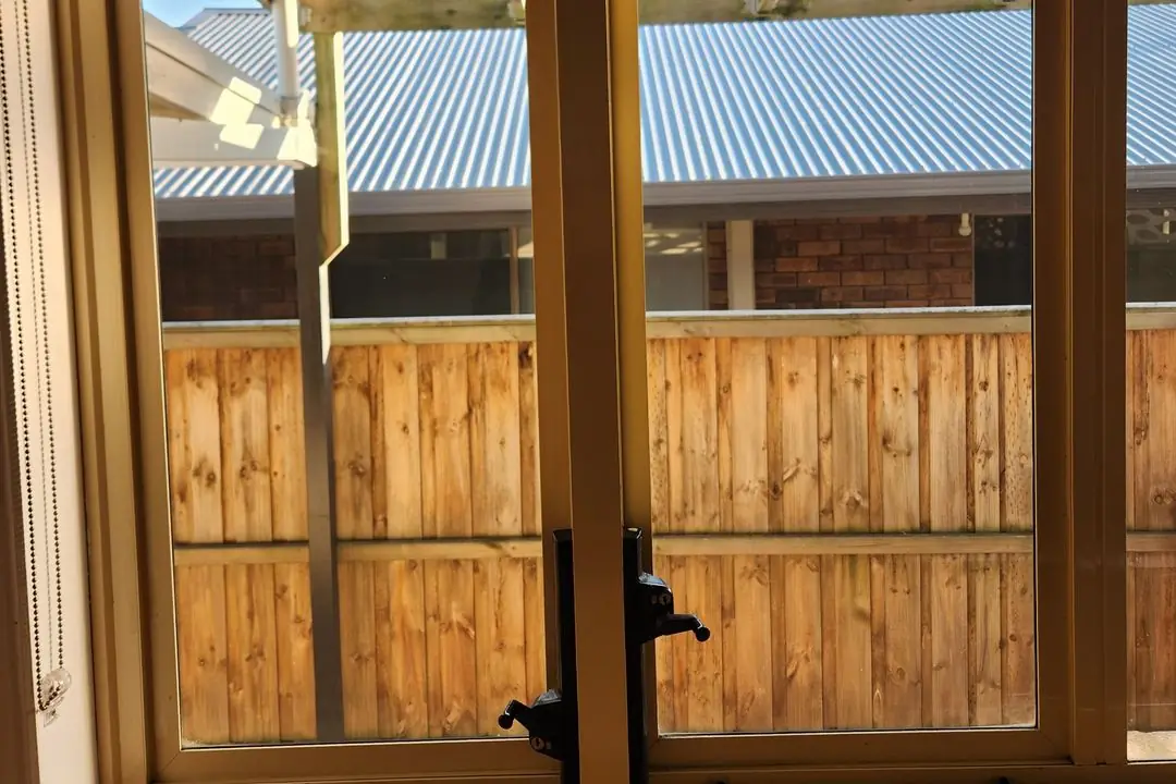 Sunlit timber-framed windows after window cleaning
