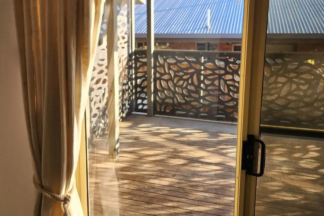 Clean sliding glass door opening onto a deck